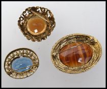 Three large vintage brooches set with agate and large faceted stones.