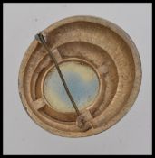 A large vintage gold tone brooch with central faceted citrine style stone.