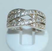 A 925 silver ring with channel set CZ in a cross over setting. Size M.
