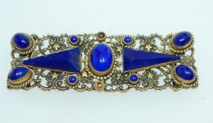 A 1930s Bohemian yellow metal filigree cloak clip clasp set with opaque blue glass carbochons