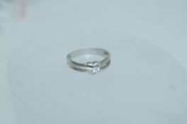 A 925 silver ring set with a clear round cut stone within a heart setting with pierced fluted