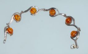 A 925 silver bracelet set with amber cabouchons in peacocks eye stylized silver links with lobster