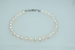 A white metal baroque pearl bracelet.