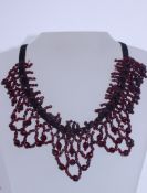 A 19th century festoon garnet bead choker necklace with 9ct plus gold clasp, being hand beaded,