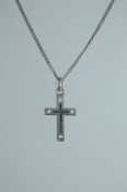 A 925 silver pendant necklace strung with an a pierced crucifix pendant on a silver chain.