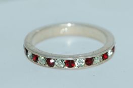 A 925 silver eternity ring with channel set clear and red stones. Size L. Weight 2.