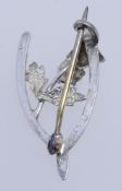A vintage scottish silver wishbone brooch with thistle set with a yellow paste stone marked WBs