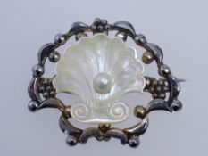 A 1950s white metal and mother of pearl brooch with faux marcasite,