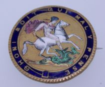 An early 20th century yellow metal and enamel brooch badge of St George slaying a dragon with the