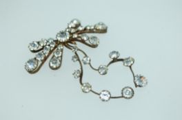 A Victorian large white metal paste set Adams bow pendant motif. Measures 7cms x 6cms.