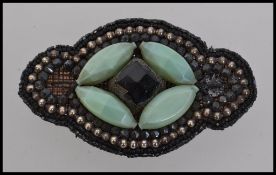 A large early 20th century hand sewn funeral Jet and bakelite beadwork motif. Measures 10cms.