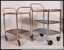 2 vintage mid century retro hostess trolleys, one in blue, the other faux wood.
