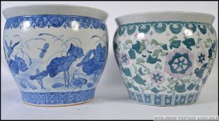 A large Chinese blue and white ceramic carp bowls / planter with decorative designs having greek