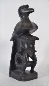 An unusual carved ebony / hardwood tribal totem / sculpture raised on plinth of a seated man with