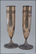A pair of silver hallmarked solifleur bud vases of cylindrical form with ribbed tops bearing