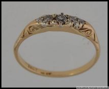 An 18ct gold ring set with three diamonds in a gypsy settings Marked 18ct Plat. Weight 2.1g. Size N.
