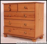 An antique style pine chest of drawers having short and deep drawer configuration.
