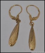 A pair of 9ct gold drop earrings with Art Deco chevron decoration. Marked 9ct K&L. Weight 1.