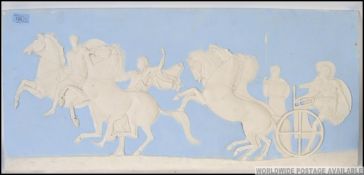 A large Wedgwood style wall plaque raised in relief with classical scenes 38x82cm