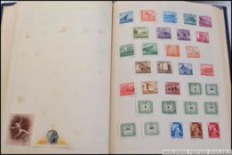 A vintage Amherst stamp album, filled with assorted overseas / foreign vintage stamps,