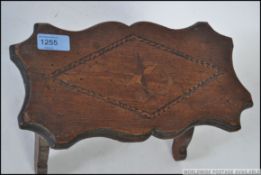 A Victorian tubbridge ware inlaid stool of apprentice piece size raised on lyre shaped supports