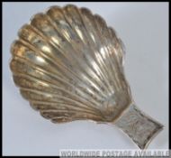 A hallmarked silver shell form spoon 14.