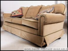 A fabulous Wesley Barrell upholstered three seat scroll arm sofa settee of excellent quality having