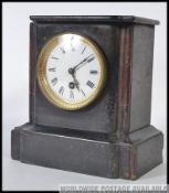 A Victorian mahogany slate mantel clock having decorative dial with 8 day movement ( brass ) set