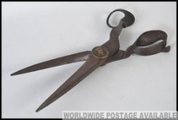 A large pair of oversized drapers or tailors scissors, marked R.Heinisch inventor Newark N.J. U.S.