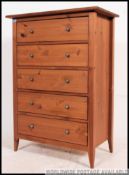 A contemporary beech wood upright pedestal chest of drawers.