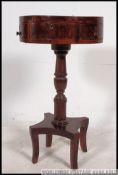 A 19th century Regency mahogany drum table / occasional table raised on quadruped base with turned
