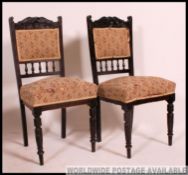 A Pair of Victorian ebonised mahogany spindle back decorated dining chair raised on turned legs