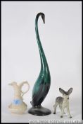A Belleek Irish black mark jug with cream glaze together with a Beswick donkey and a swan figurine