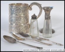 A collection of flatware to include a Silver hallmarked candle stick,