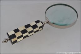 A large hand held magnifying glass,