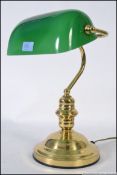 A vintage original bankers desk lamp, of brass construction with a green glass shade.
