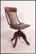 A good 1920's oak Industrial office swivel chair raised on quadruped base with fan back rest and