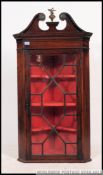 A 19th century Georgian / Regency mahogany corner cabinet having full length astagal glazed door.