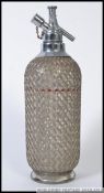 A vintage 20th English made French / Czech influence soda syphon with metal / wirework covered