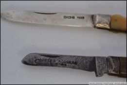 A hallmarked silver opening pen knife with mother of pearl handle,
