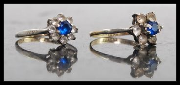 2 silver 925 and blue sapphire type stone set daisy head rings. Total weight 3.