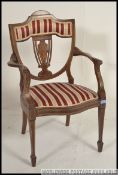 An Edwardian inlaid elbow chair, with central pierced splat, with scrolls and central lyre,