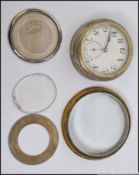 An early 20th century car clock ( pocket watch style ) having key wind movement,