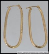 A pair of 9ct gold hoop earrings with etched decoration and post clip clasps marked 375.