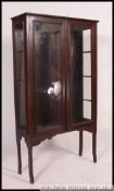 An early 20th century country oak bookcase display cabinet on stand.
