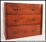 A Victorian mahogany chest of drawers with brass handles to the 3 drawers havin unusual upcycled