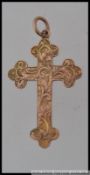A 9ct gold hallmarked crucifix pendant with foliate chased decoration. Hallmarked for Birmingham .