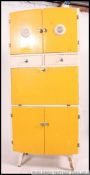 A mid century vintage two tone yellow and white kitchen cabinet comprising drawers and cupboards.