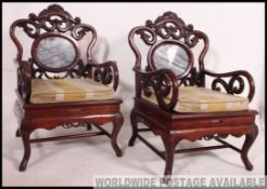 A pair of 20th century Chinese hardwood and marble armchairs / elbow chairs.