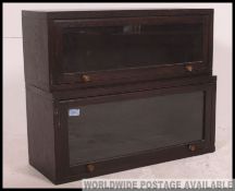 A pair of stacking Globe Wernick style solid oak Lawyers bookcase cabinets each glazed up and over